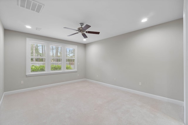 carpeted spare room with ceiling fan