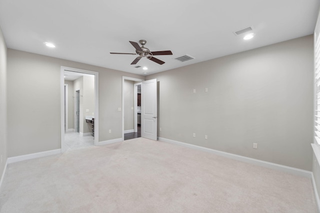 unfurnished room featuring light colored carpet and ceiling fan