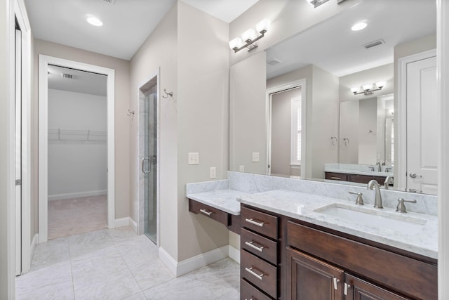 bathroom with vanity and a shower with shower door