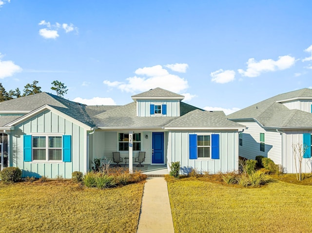 view of front of home with a porch and a front lawn