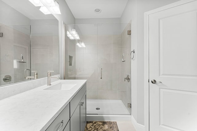 bathroom with walk in shower, tile patterned floors, and vanity