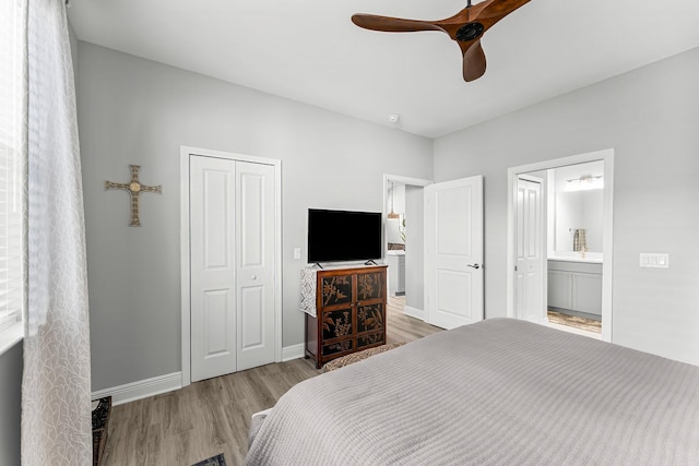 bedroom with ceiling fan, connected bathroom, a closet, and light wood-type flooring