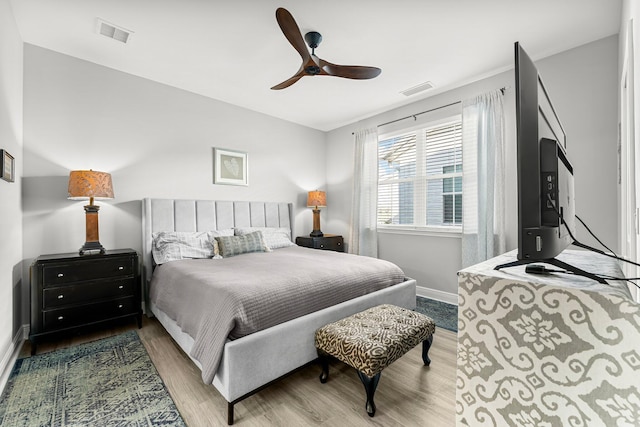 bedroom with ceiling fan and hardwood / wood-style floors