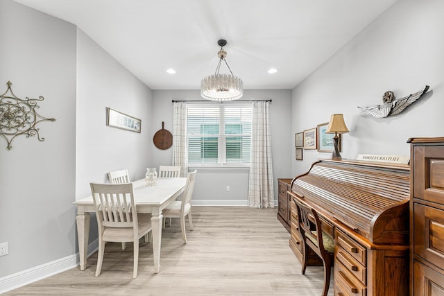 dining space with an inviting chandelier and light wood-type flooring