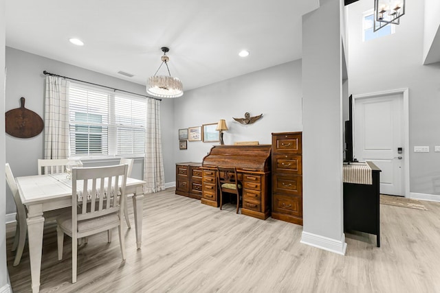 dining area featuring a chandelier and light hardwood / wood-style flooring