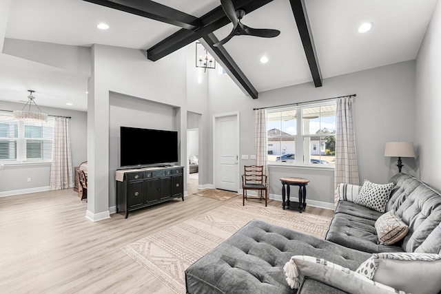 living room featuring high vaulted ceiling, a wealth of natural light, beam ceiling, and light hardwood / wood-style flooring