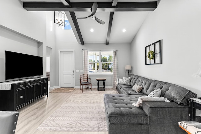 living room with beamed ceiling, ceiling fan, and light hardwood / wood-style floors