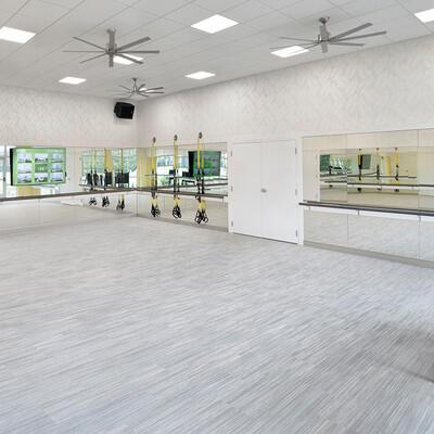 interior space with a paneled ceiling and ceiling fan