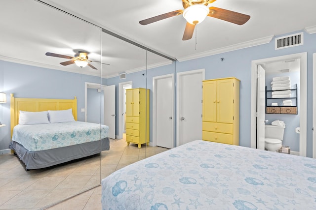 tiled bedroom featuring crown molding, connected bathroom, ceiling fan, and a closet