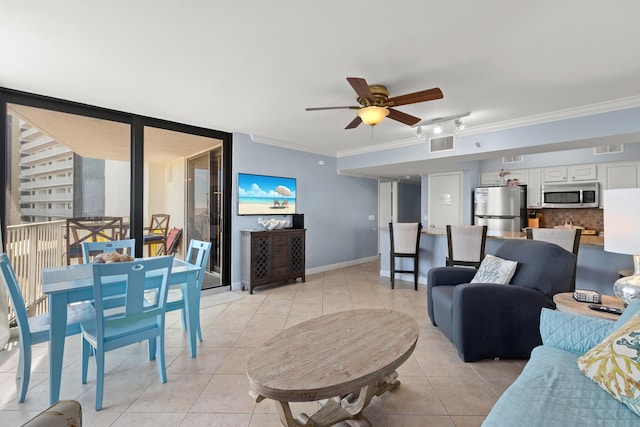 living room featuring light tile patterned floors, ornamental molding, and ceiling fan