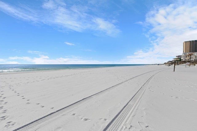 exterior space featuring a beach view and a water view