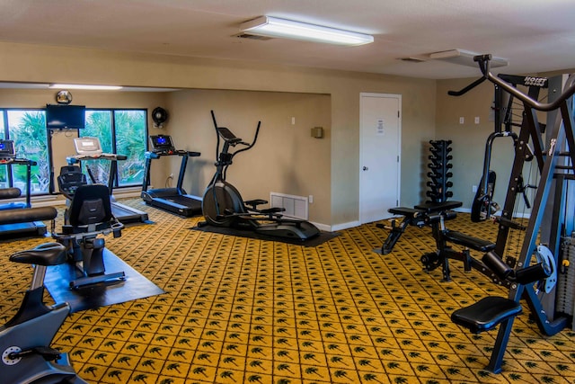 gym with carpet floors and a textured ceiling