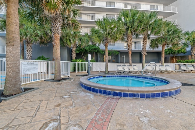 view of pool featuring a community hot tub and a patio