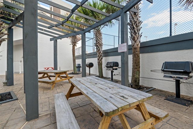 view of patio / terrace featuring area for grilling and a pergola