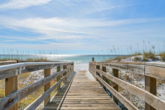 view of home's community with a water view and a view of the beach