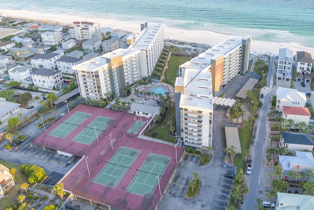 bird's eye view with a water view and a beach view