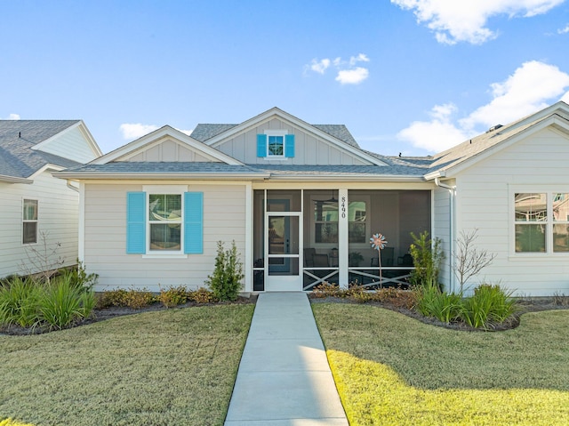 view of front of house featuring a front lawn and a sunroom