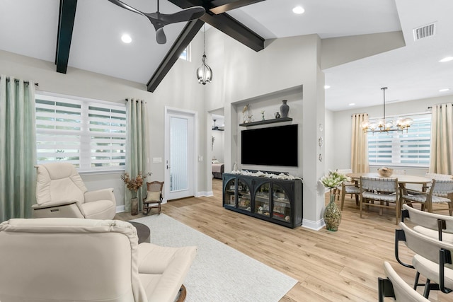 living room featuring beamed ceiling, high vaulted ceiling, ceiling fan with notable chandelier, and light hardwood / wood-style floors