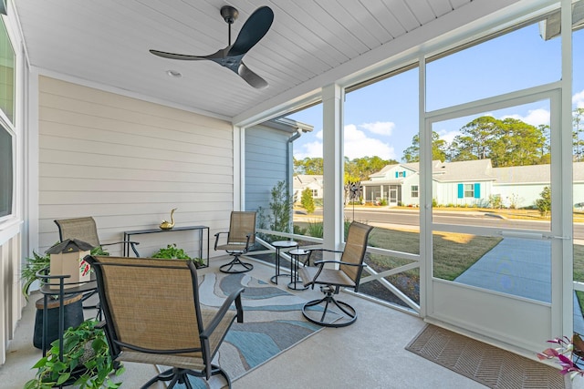 sunroom / solarium featuring plenty of natural light and ceiling fan