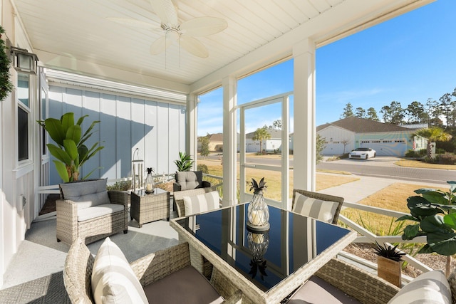 sunroom featuring ceiling fan