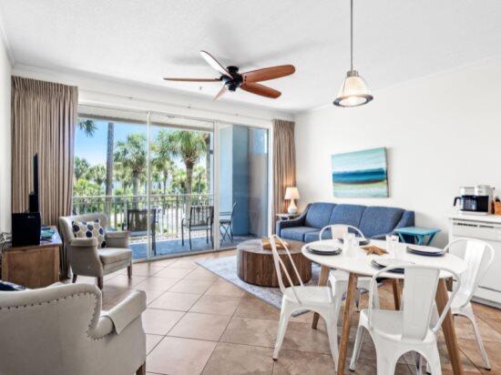 living room featuring ceiling fan and light tile patterned floors