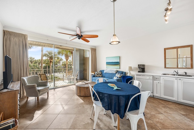 dining room with sink, light tile patterned floors, rail lighting, and ceiling fan