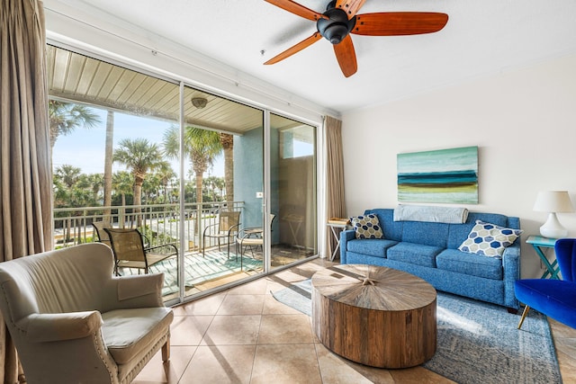 living room with plenty of natural light, light tile patterned floors, and ceiling fan