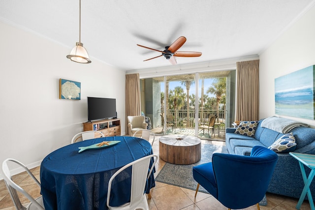 tiled living room with ornamental molding and ceiling fan