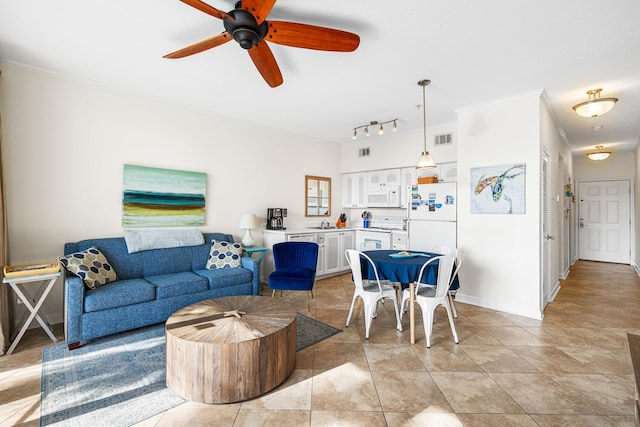 tiled living room featuring ornamental molding, rail lighting, sink, and ceiling fan