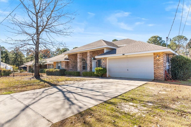 ranch-style house featuring a garage and a front lawn