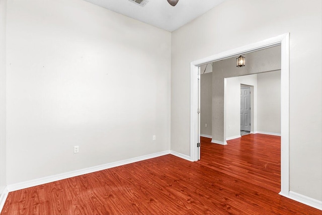 spare room featuring wood-type flooring and ceiling fan