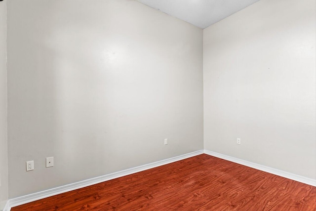 empty room featuring wood-type flooring