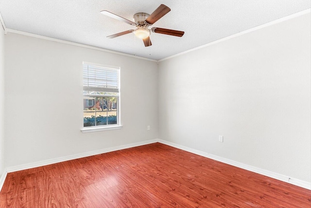 empty room featuring hardwood / wood-style flooring, ornamental molding, and a textured ceiling