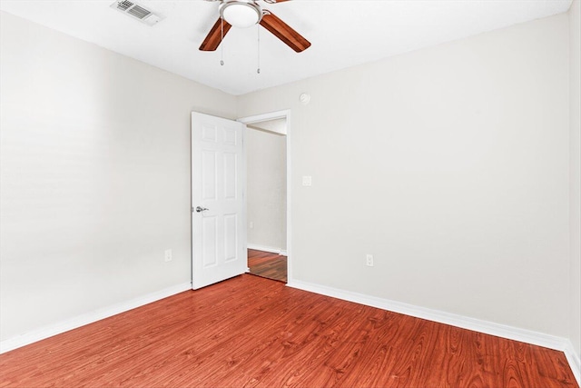 empty room with hardwood / wood-style flooring and ceiling fan