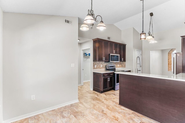 kitchen with appliances with stainless steel finishes, decorative backsplash, hanging light fixtures, dark brown cabinetry, and an inviting chandelier