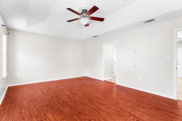 unfurnished room featuring hardwood / wood-style flooring, a textured ceiling, a raised ceiling, and ceiling fan