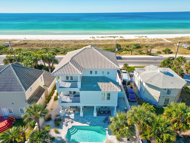 drone / aerial view with a beach view and a water view