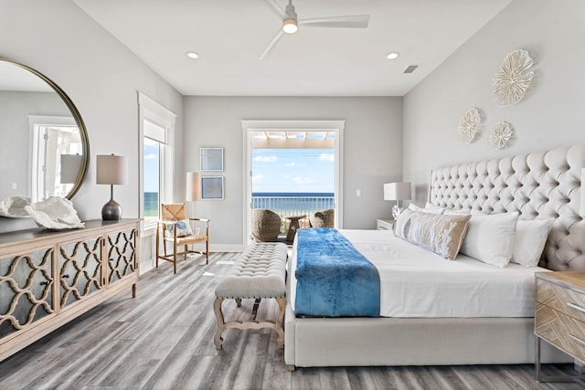 bedroom with ceiling fan, access to exterior, and hardwood / wood-style floors