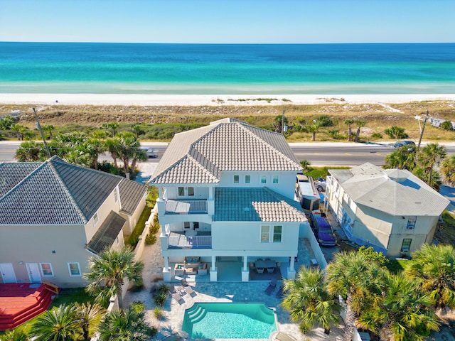 bird's eye view with a water view and a beach view