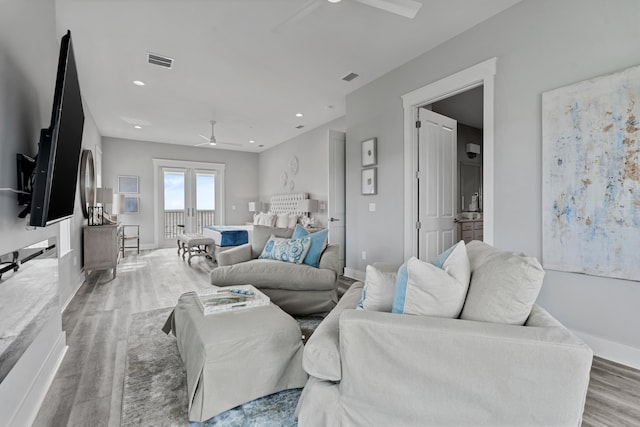 living room with hardwood / wood-style floors and ceiling fan