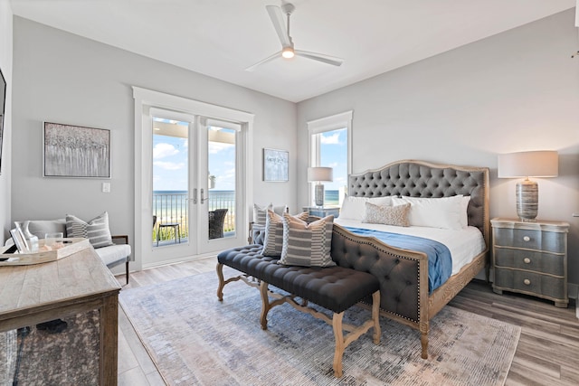 bedroom with hardwood / wood-style flooring, ceiling fan, french doors, and access to outside