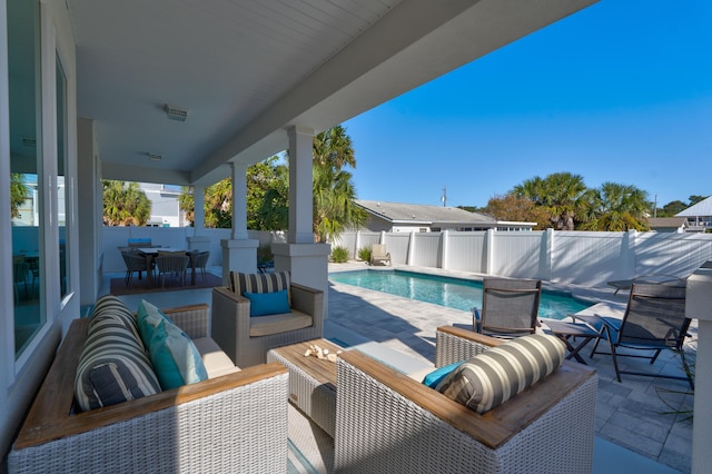 view of patio with an outdoor living space and a fenced in pool