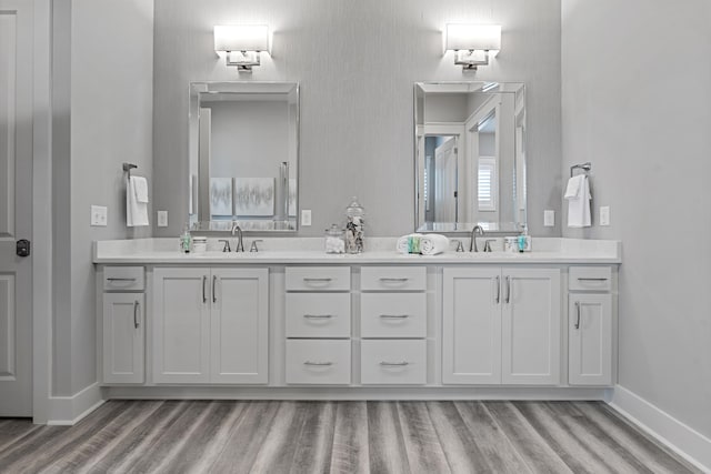 bathroom with vanity and hardwood / wood-style flooring