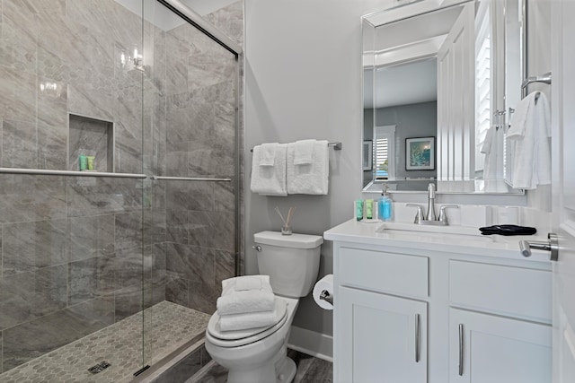 bathroom with walk in shower, vanity, toilet, and hardwood / wood-style floors