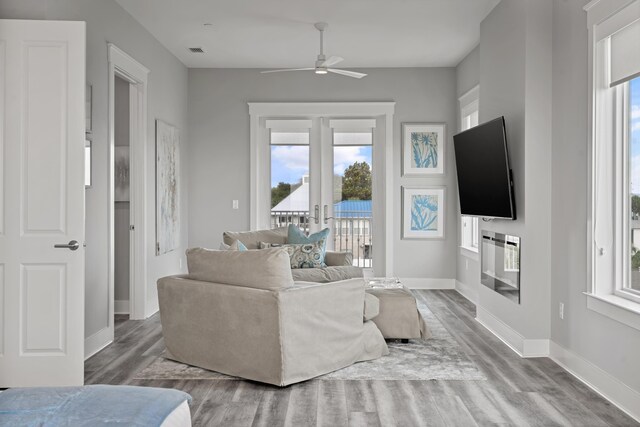 living room featuring hardwood / wood-style floors, french doors, and ceiling fan