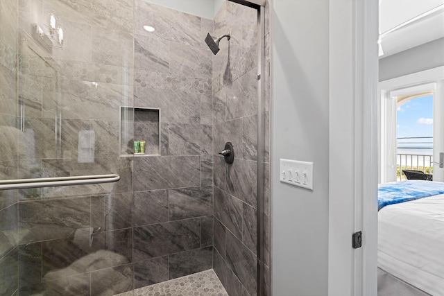 bathroom with a shower with door