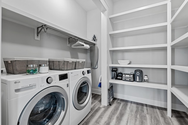 laundry area with hardwood / wood-style flooring and washer and dryer