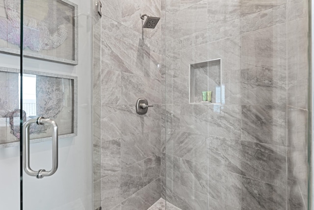 bathroom with a shower with shower door