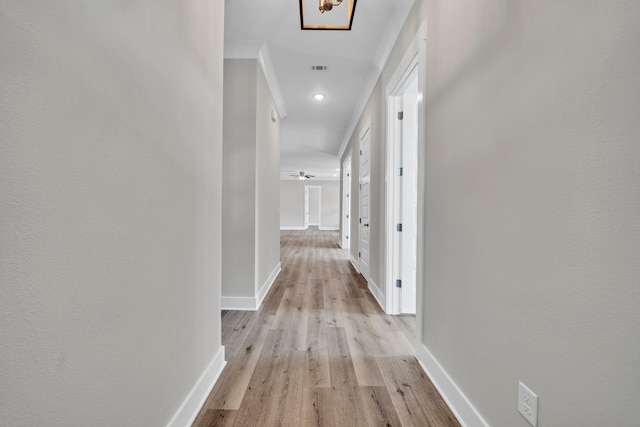 corridor featuring baseboards and light wood-style floors