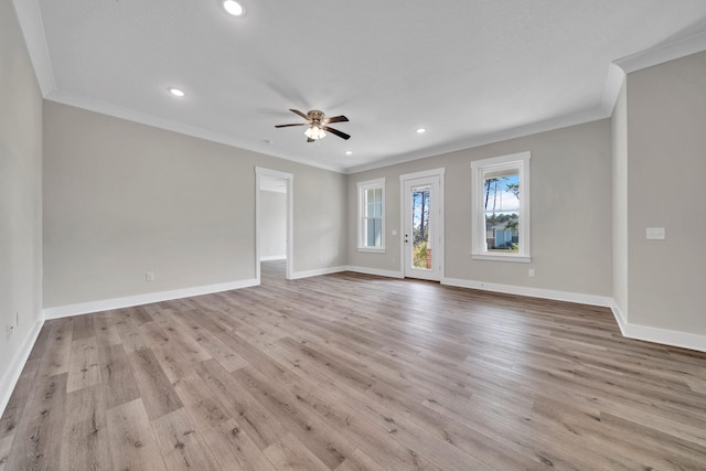 unfurnished living room with ceiling fan, ornamental molding, and light wood-type flooring